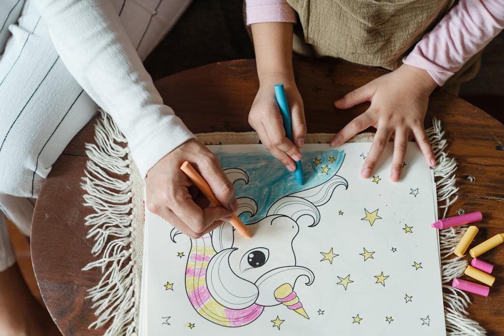 A mother and child enjoying a coloring activity with crayons at home, fostering creativity and bonding.